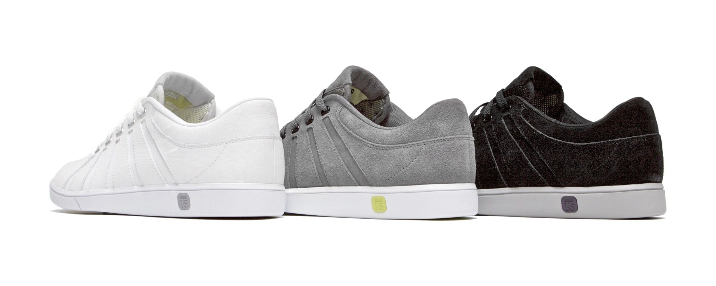 Three KS Classics in white, grey suede and black suede, each with a colored heel tab.