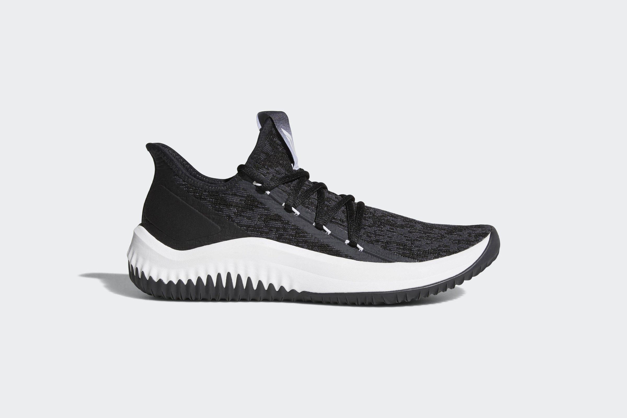 The core black Dame D.O.L.L.A. from the side, in black and grey camo knit with white lace tips and a white midsole.