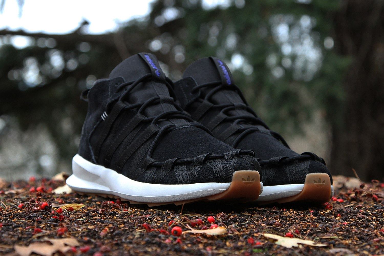 The black pair from the front three-quarter, with a purple tongue label.