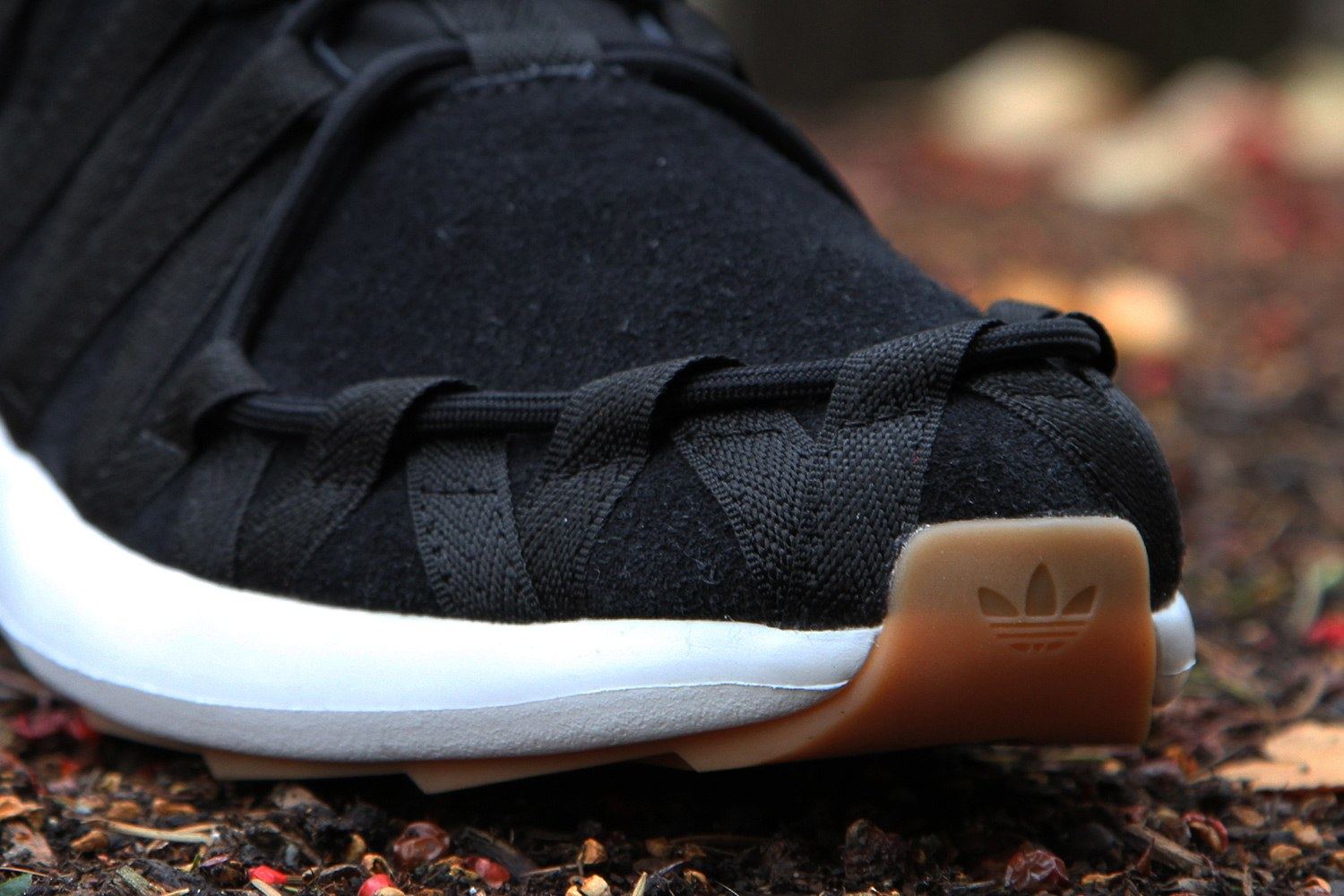Close-up of the moc toe and the gum heel with a molded Trefoil.