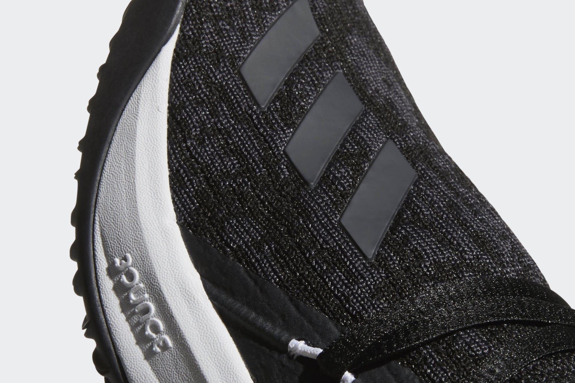 Close-up of the black knit forefoot with tonal grey stripes and Bounce molded into the white midsole.