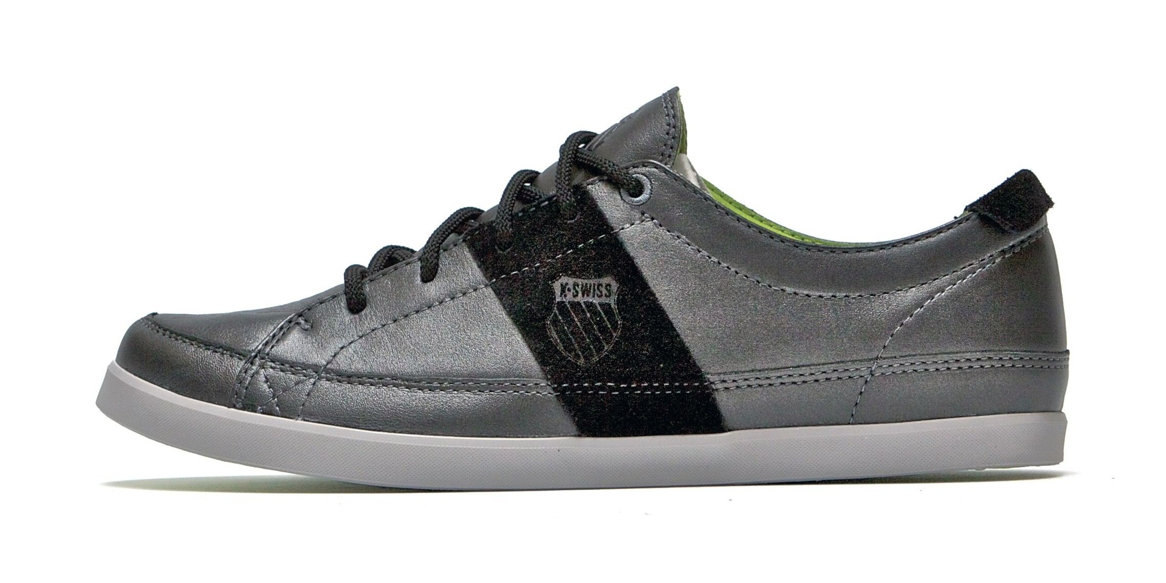 The City Tennis in black leather with a black suede band, a debossed shield, a lime lining and a grey sole, side view.