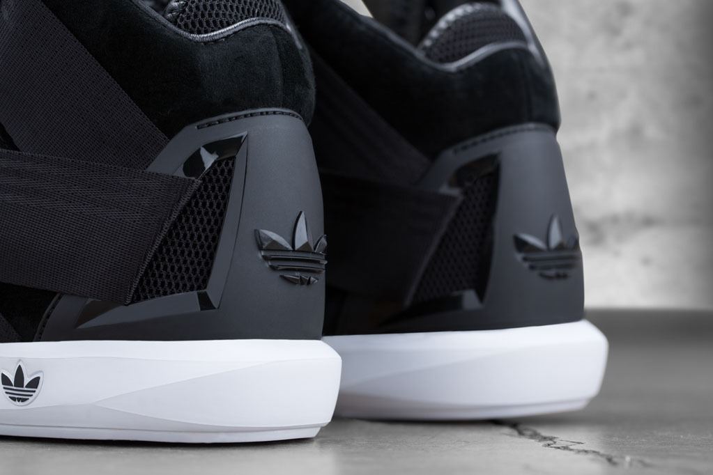 Low view of the black heel counters, Trefoil logos and white midsoles.