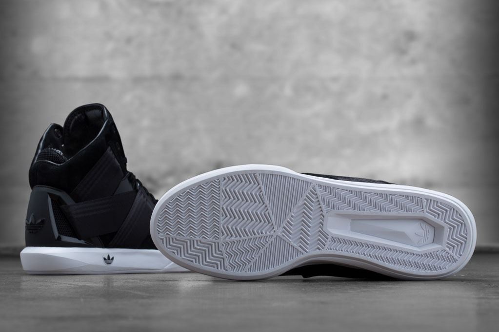 The black and white C-10, one shoe from the side and one turned over to show the white outsole.