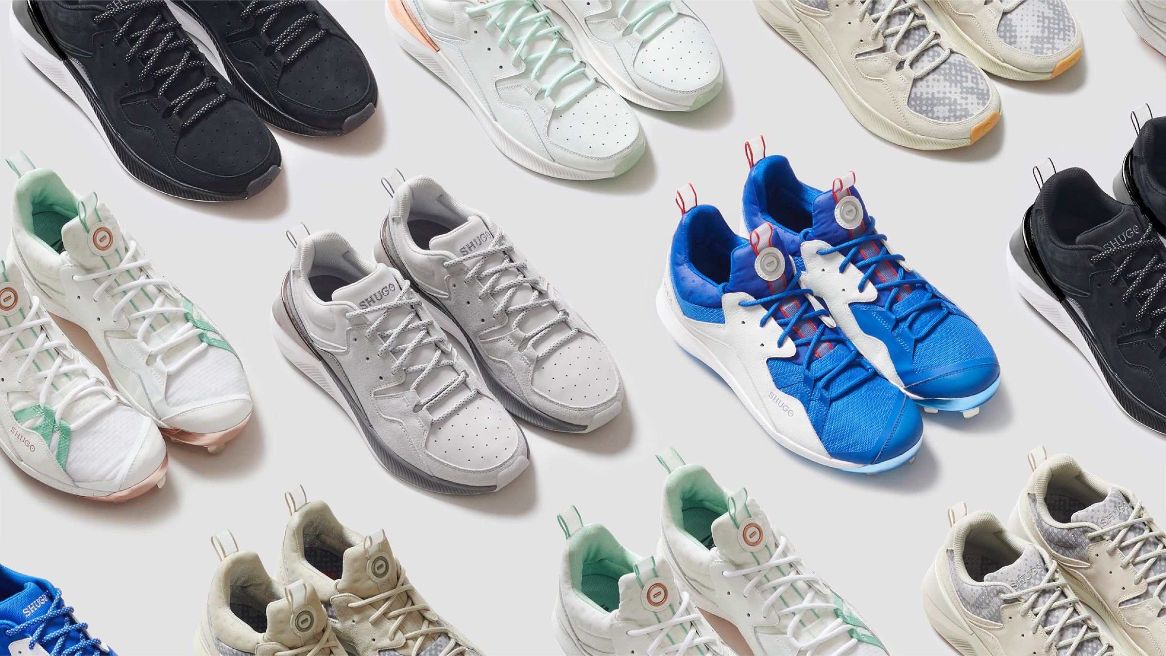 Rows of SHUGO cleats and trainers laid out on the diagonal, in black, white, mint, cream, grey, and royal blue colorways.