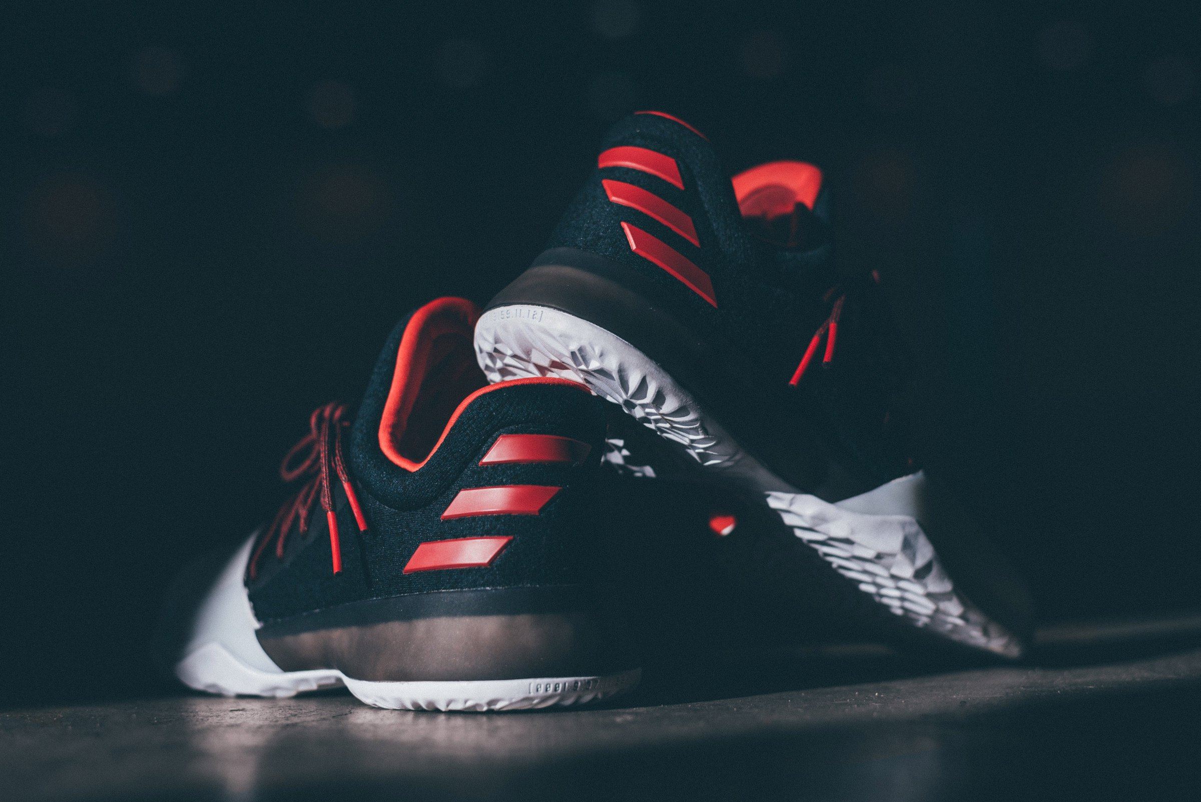 Low-angle view of the heel with red three-stripe detail and the Boost midsole.