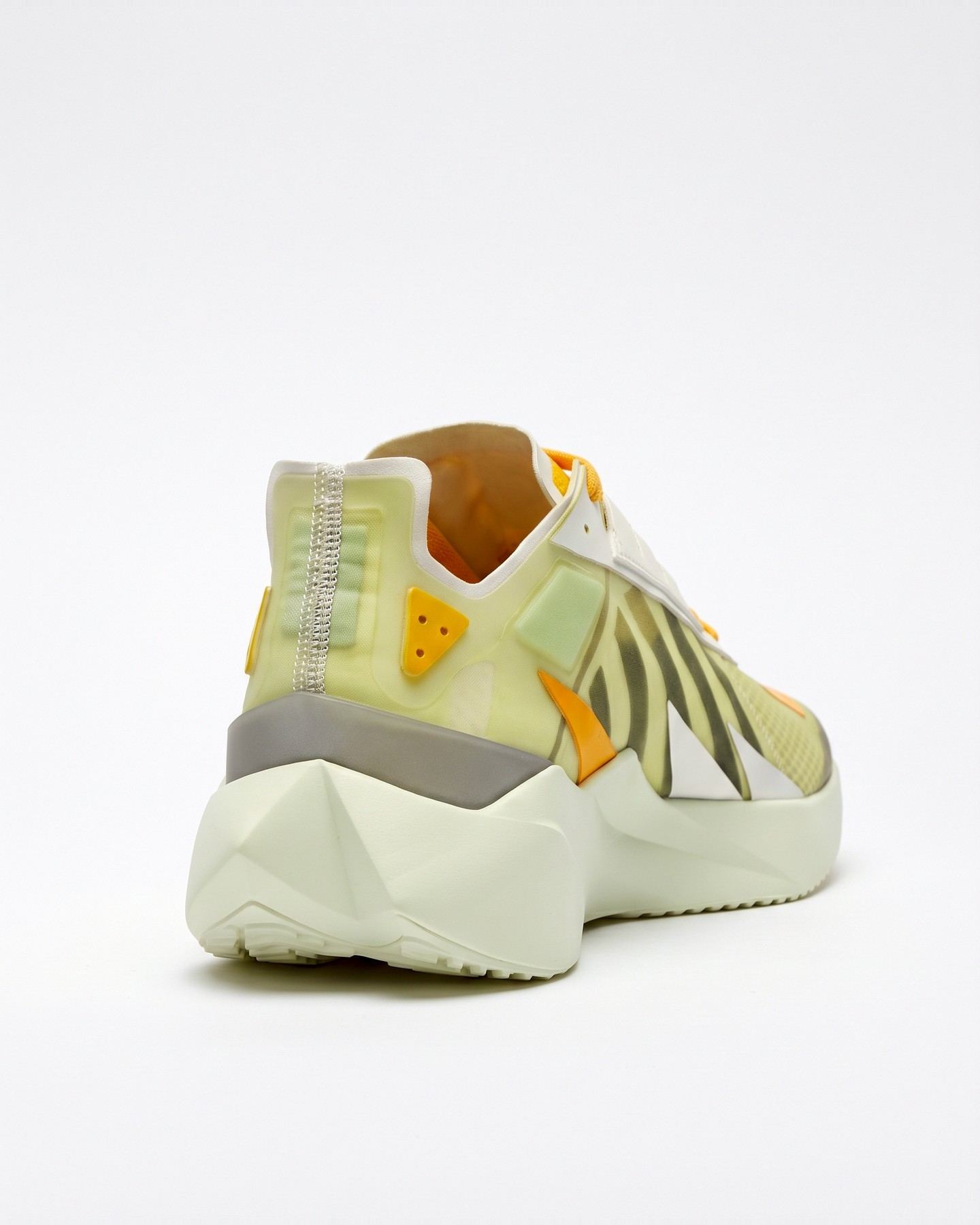 The finished shoe from behind, with a translucent heel counter, a yellow heel tab, and a faceted off-white midsole.