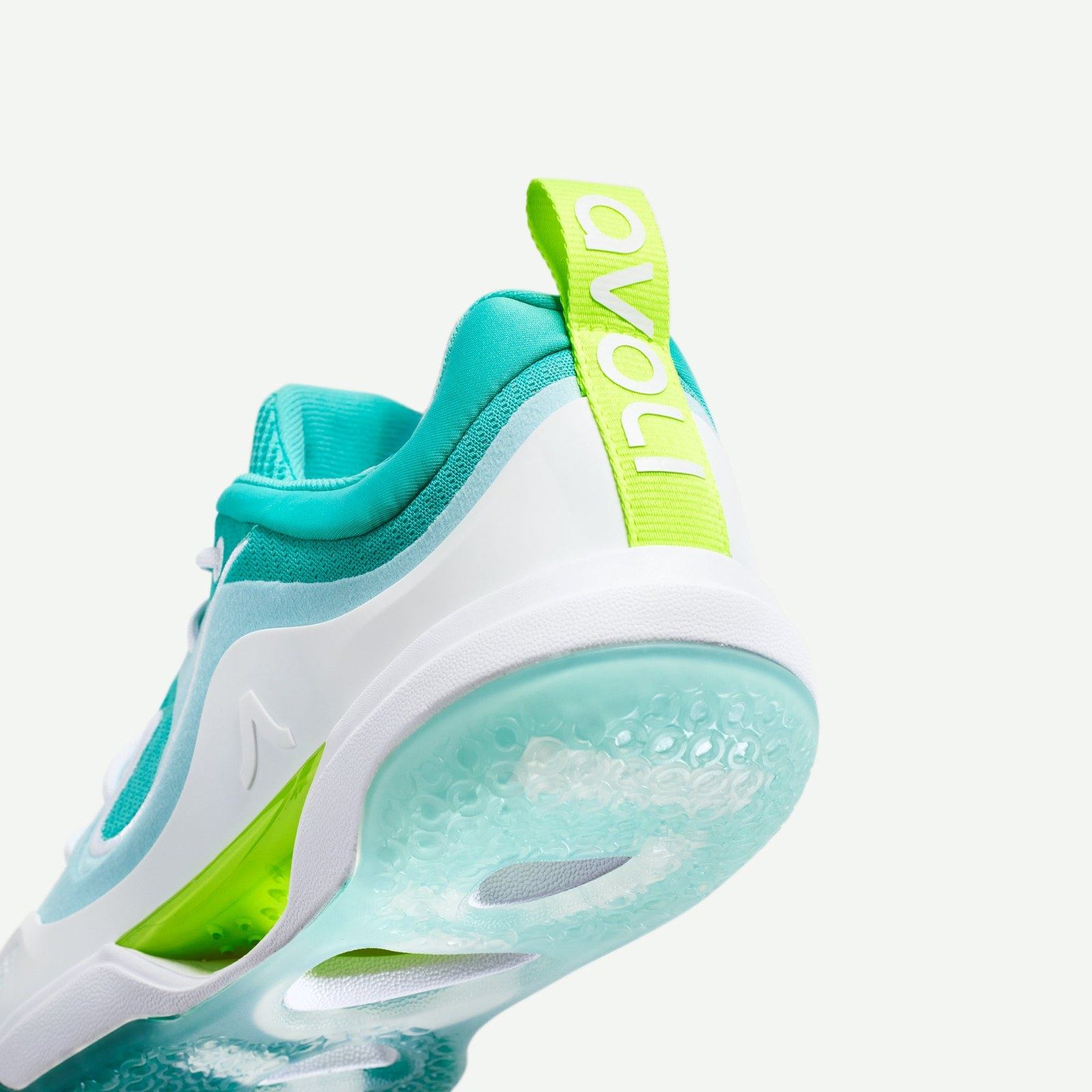 The teal Low from below the heel, with a lime avoli heel tab and a translucent aqua outsole.