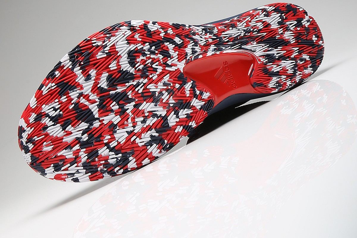 Full outsole in red, white, and navy camo rubber with a red midfoot window.