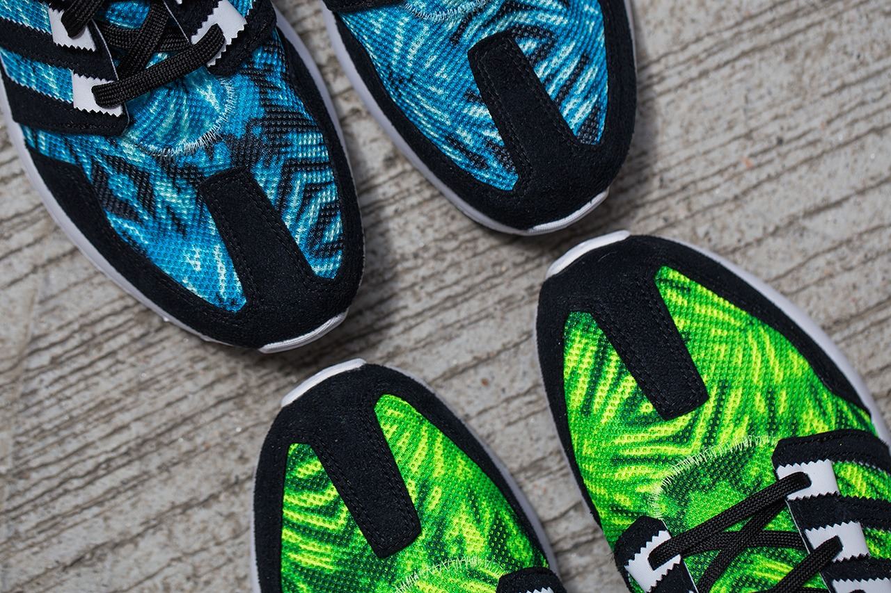 Overhead view of the green and teal palm print colorways side by side on concrete.
