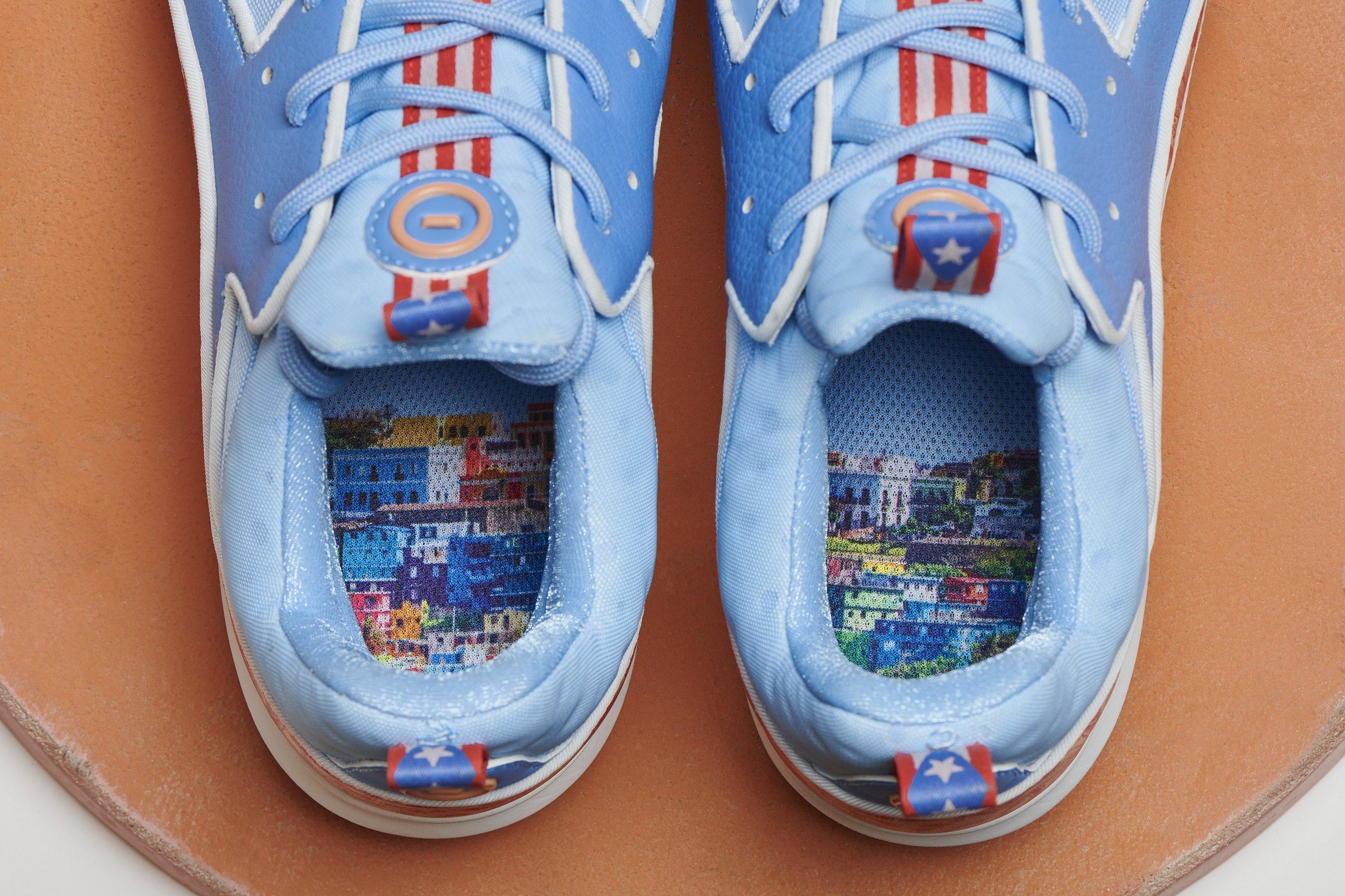 Looking into the pair, sockliners printed with the colorful houses of Old San Juan, on a terracotta disc.