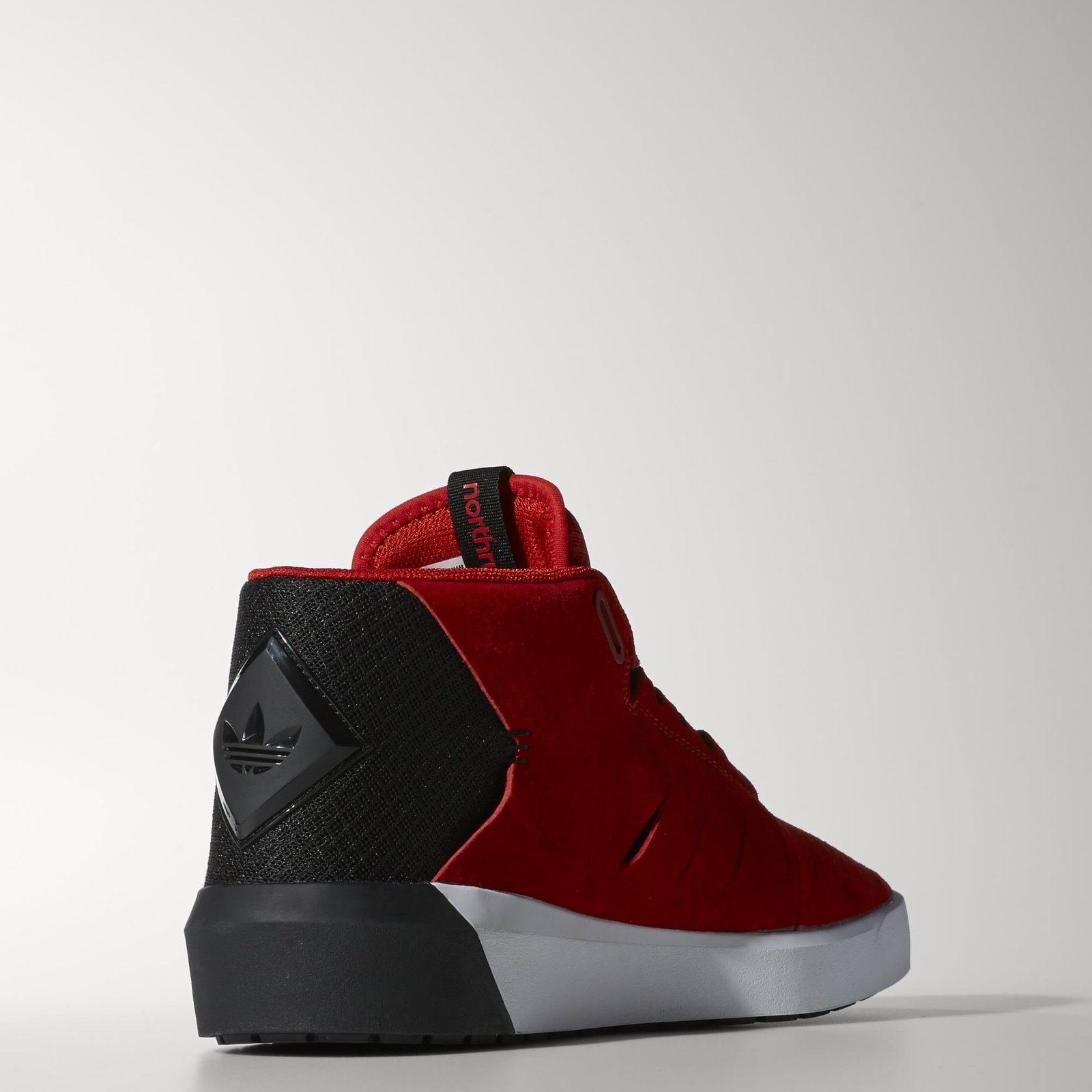 The red Northrup from the back three-quarter, with a black heel panel and a molded Trefoil badge.