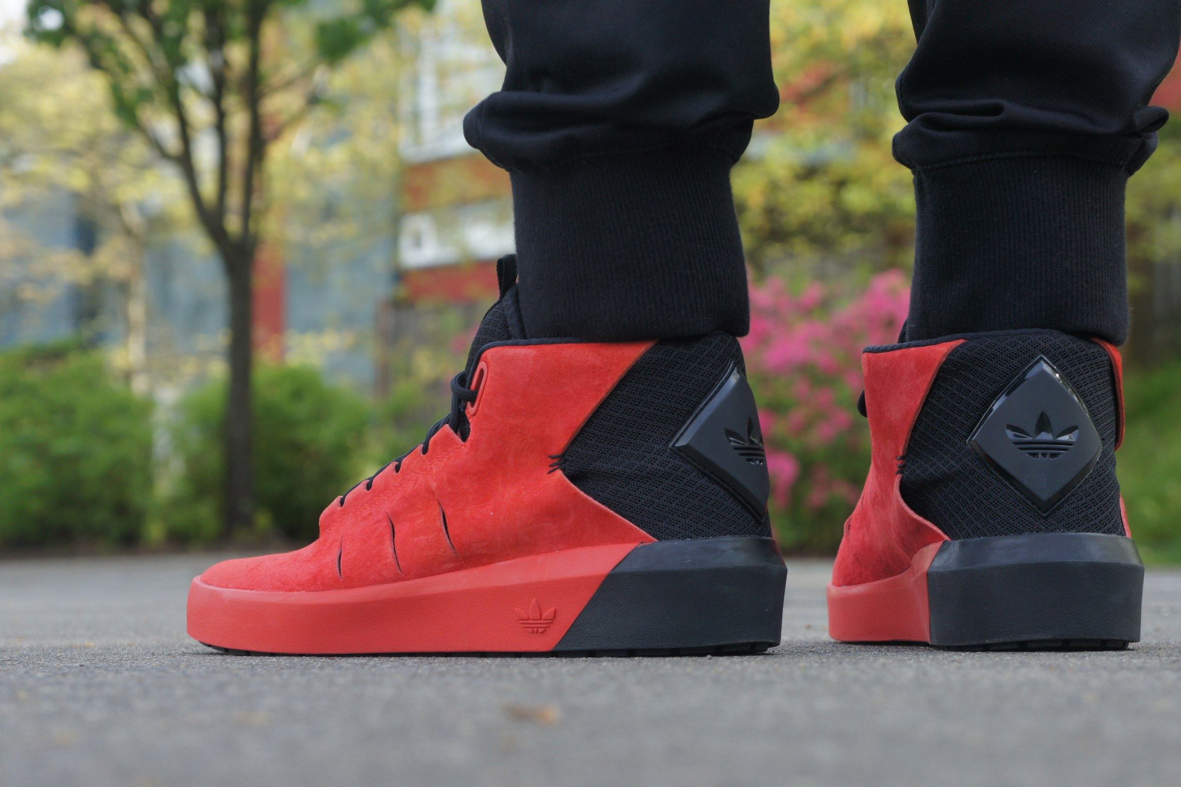 The red Northrup on foot, one from the side and one from the back.
