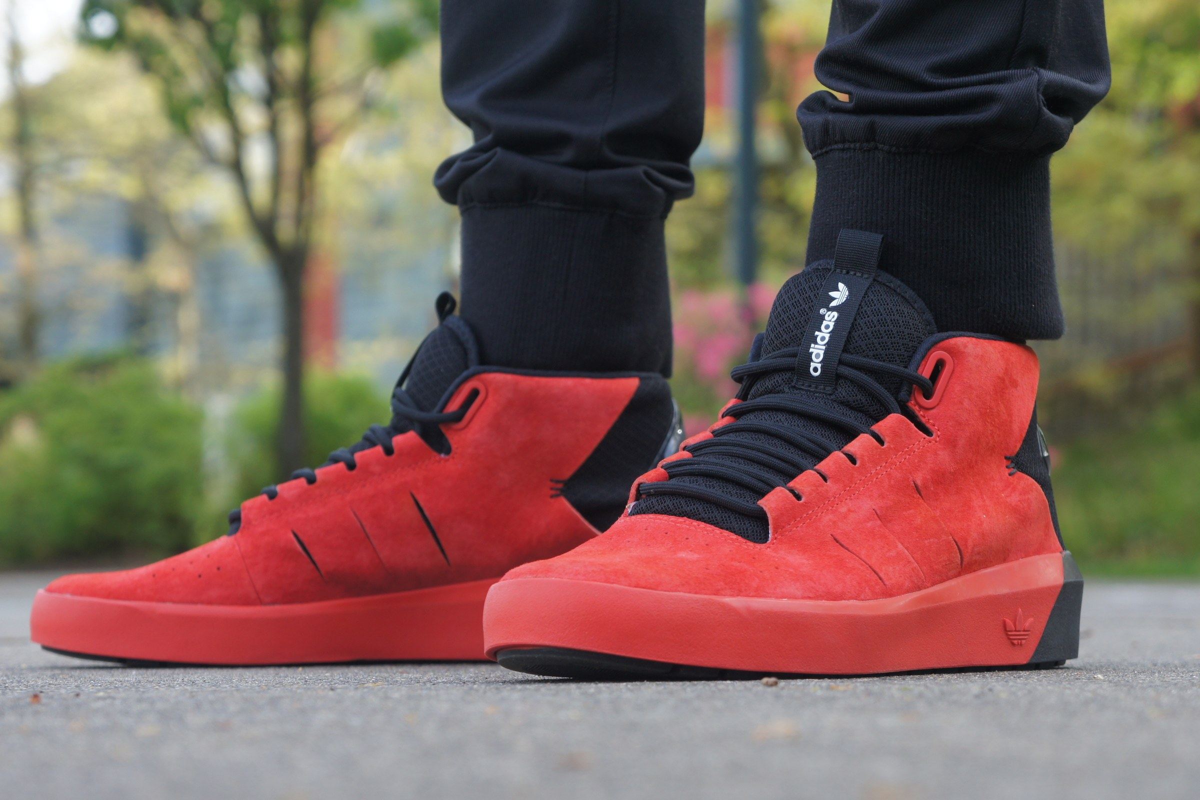The red Northrup on foot from the front, red suede with a black mesh collar and a black and red cupsole.