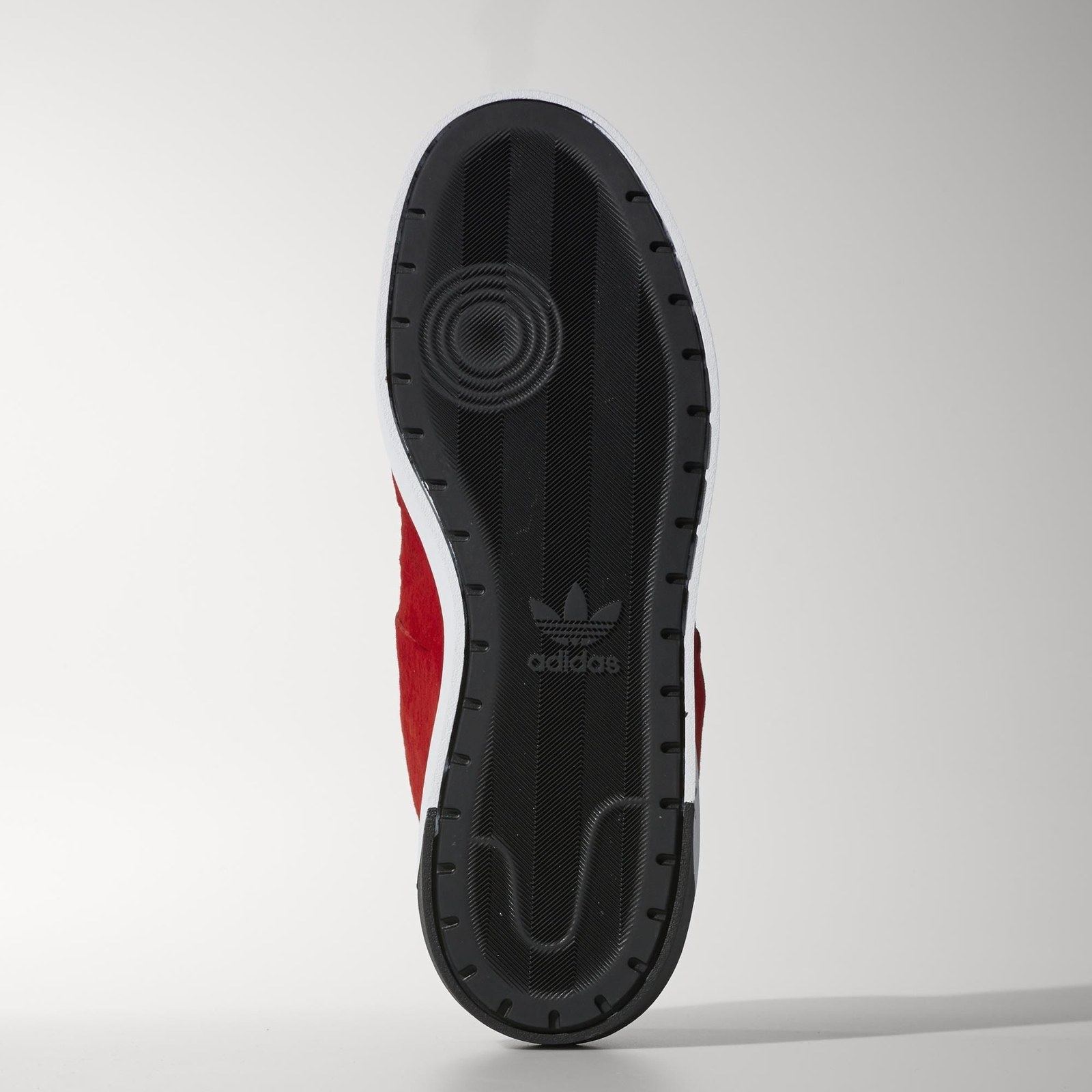 The black outsole with a circular pivot point and a Trefoil at the arch.