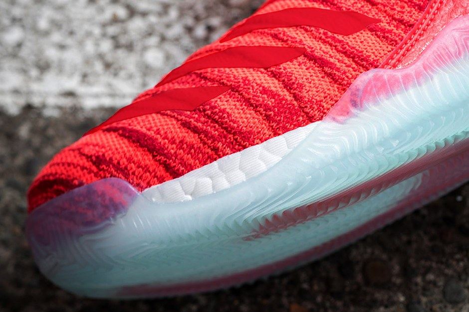 Close-up of the red knit forefoot with tonal stripes over white Boost and an icy blue outsole.
