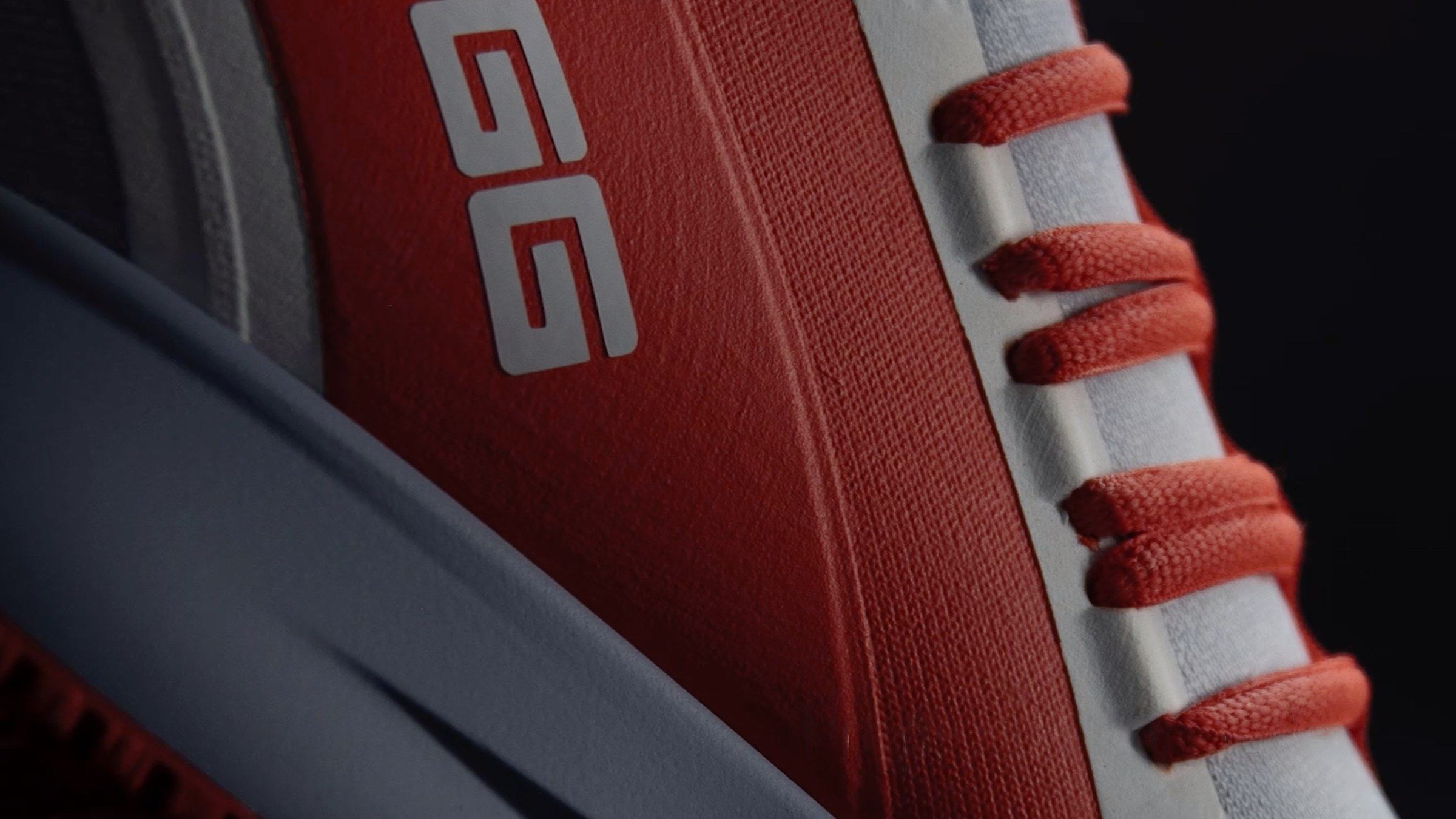 Close-up of the red heel panel with the SIGG wordmark and red laces.