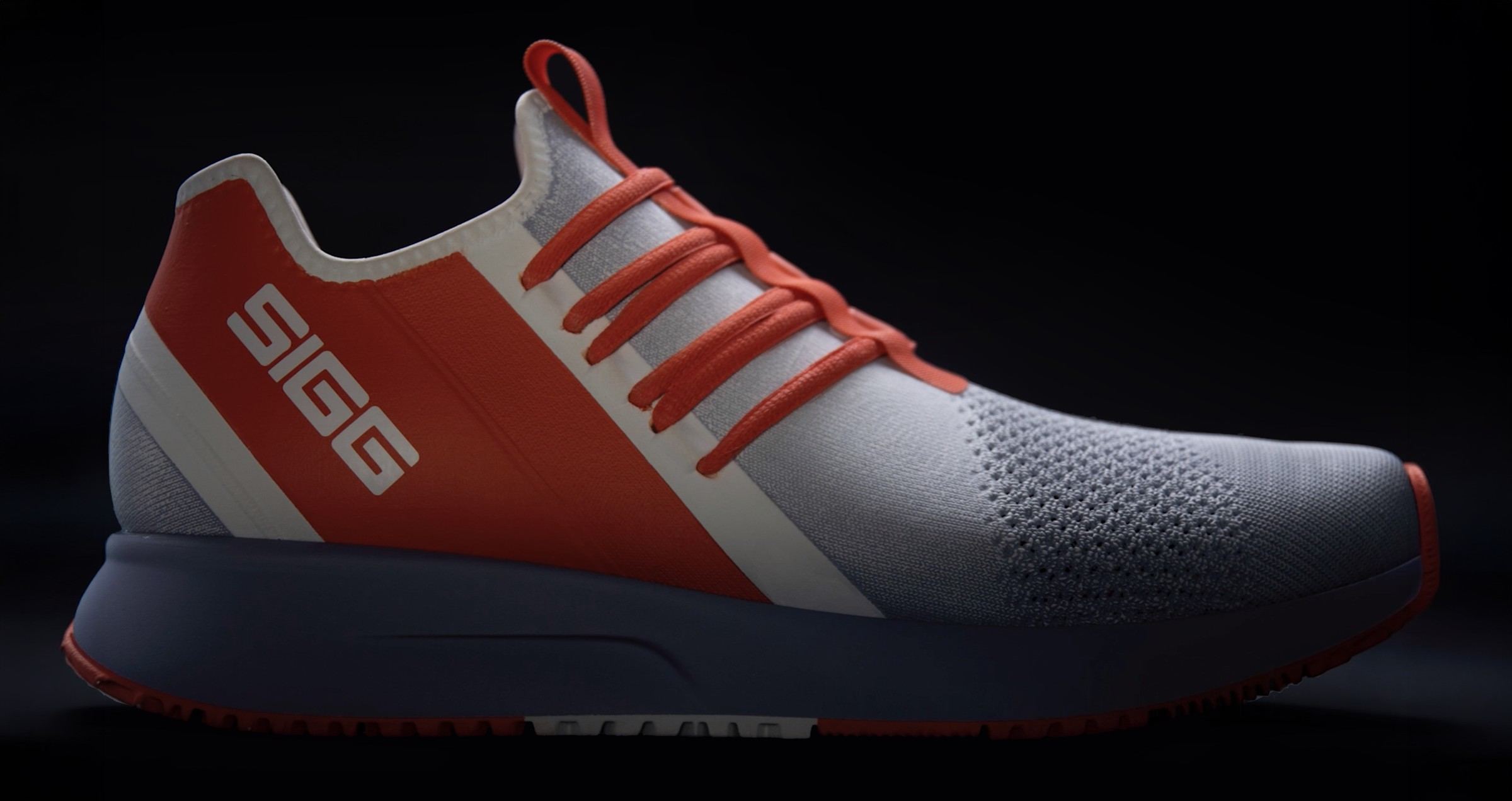 3D rendering of the shoe in white knit with a red diagonal panel, white SIGG wordmark, and red laces, lateral view on a dark backdrop.