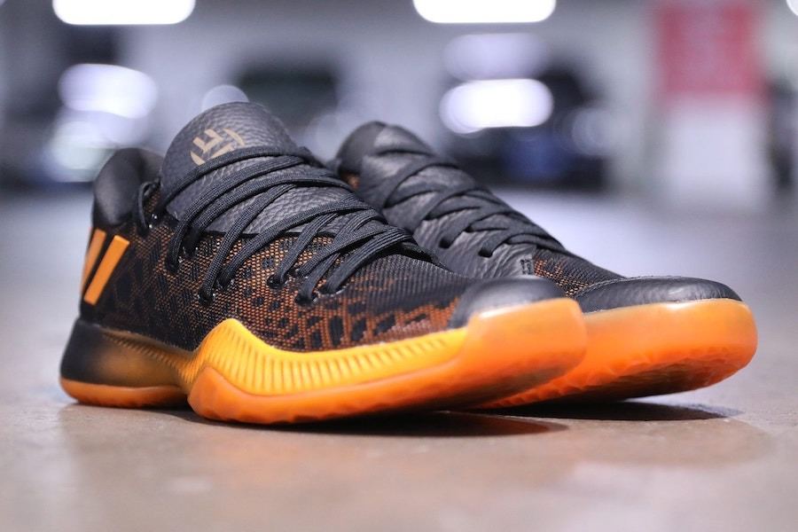 A pair of the black and orange Harden BTE from the toe, three-quarter view.
