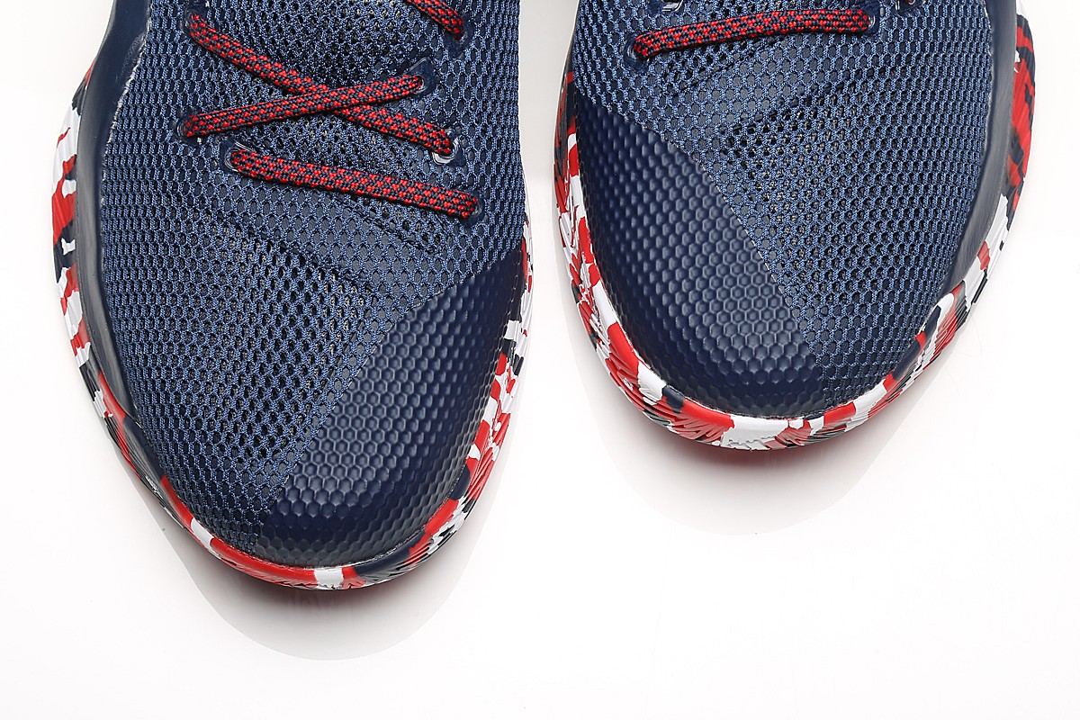 Top-down view of both toes in navy mesh with red laces and camo midsole edges.