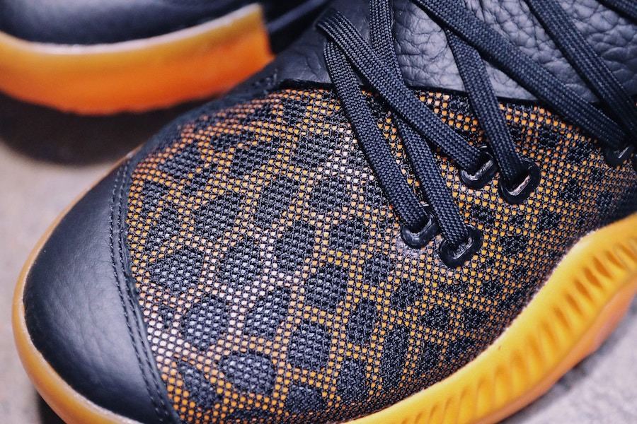 Close-up of the leather toe cap and cheetah-print mesh at the forefoot.
