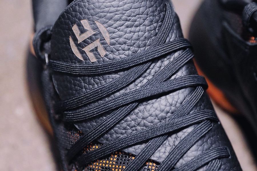 Close-up of the Harden logo on the black leather tongue under black laces.