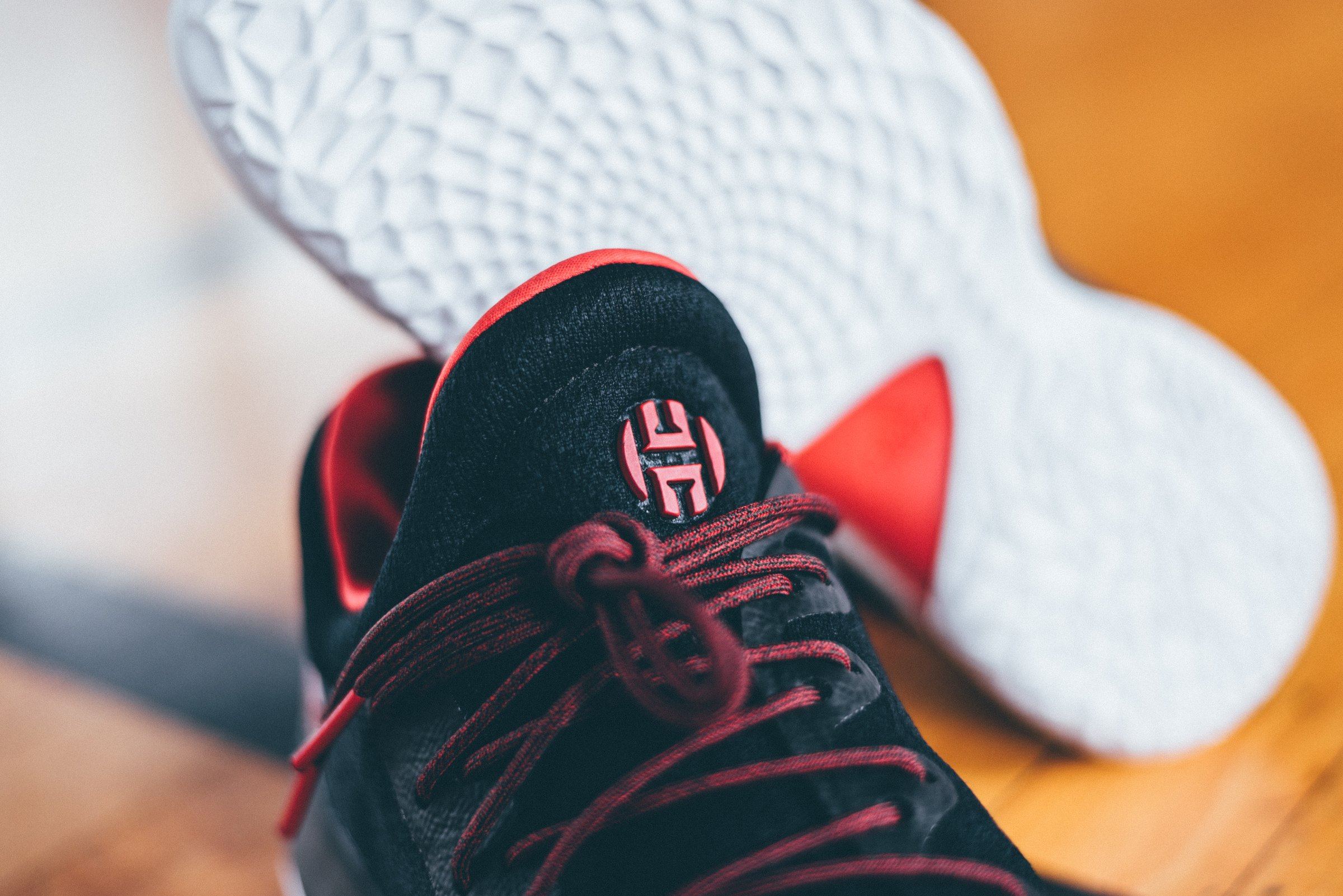 The H logo on the tongue with the outsole curving behind it.