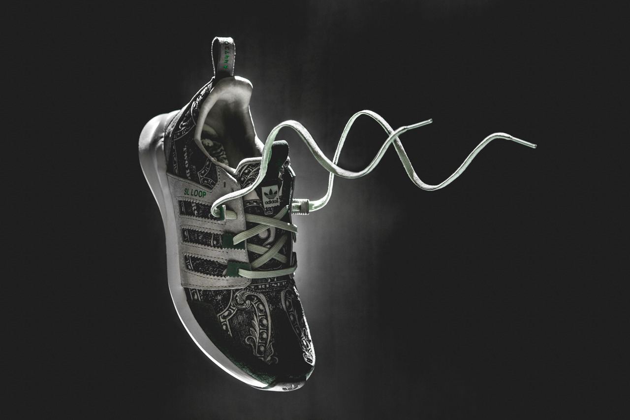The Wish banknote-print shoe with its white laces loose and floating.