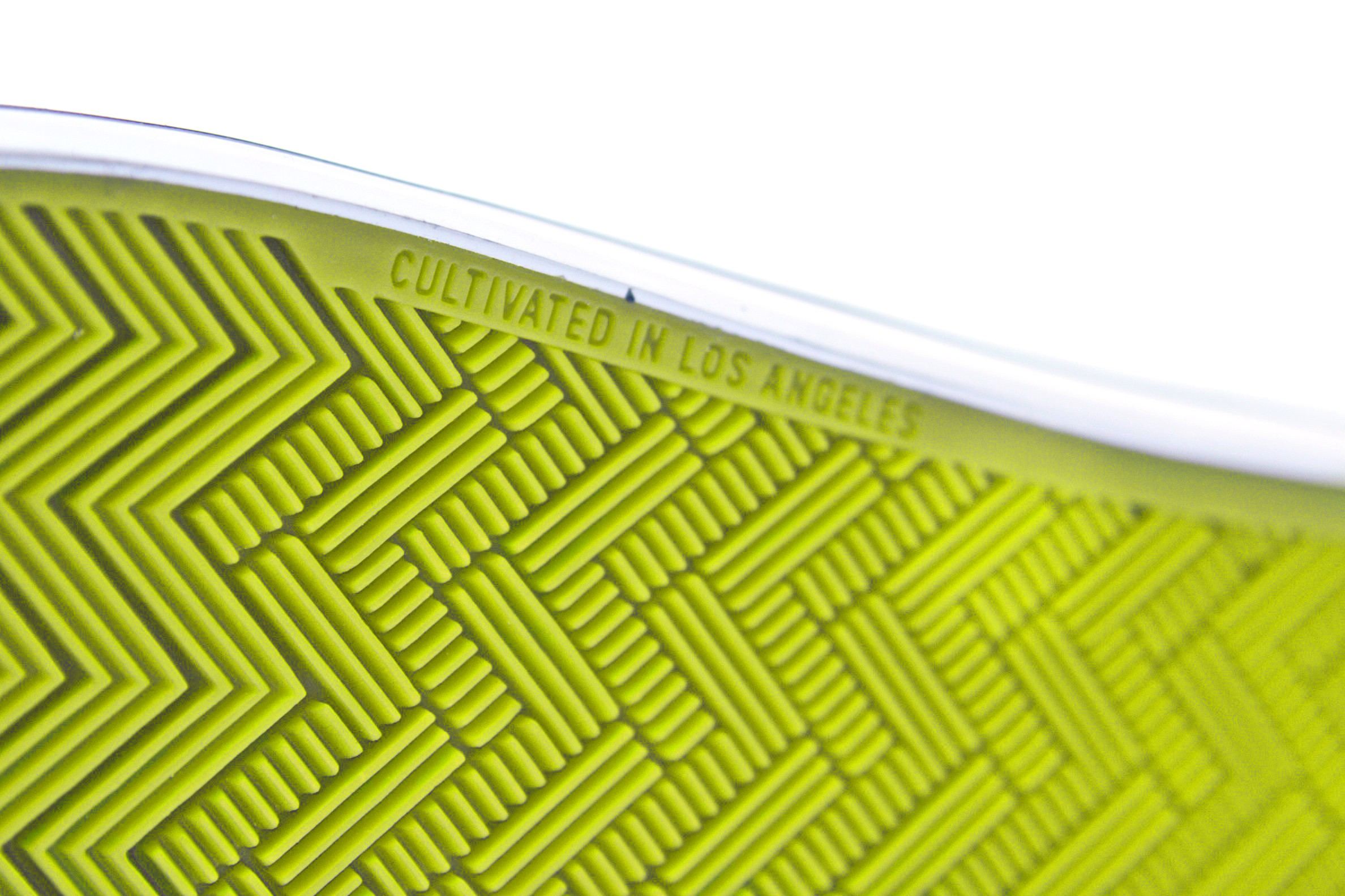 Close-up of the neon yellow tread with Cultivated in Los Angeles molded into the sole.