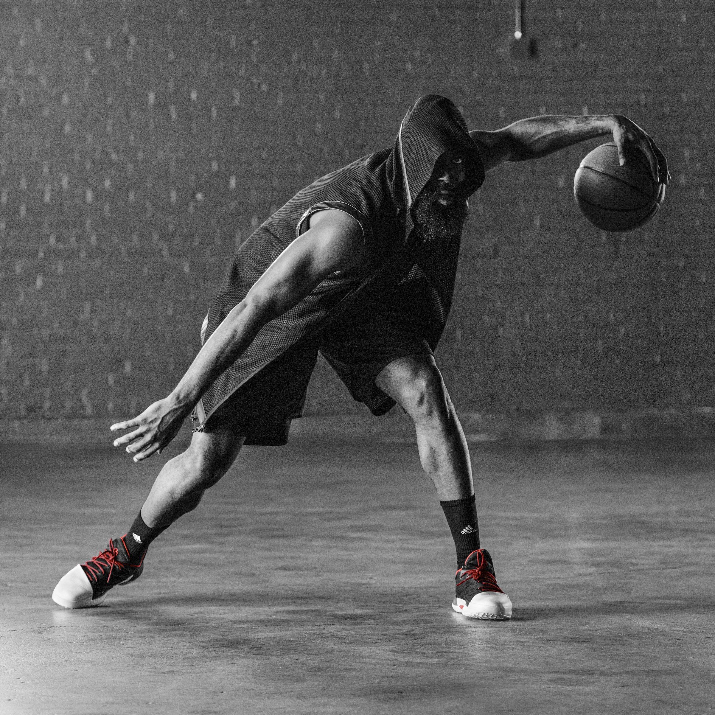 Black-and-white photo of a player in a low crossover dribble wearing the Harden Vol. 1.