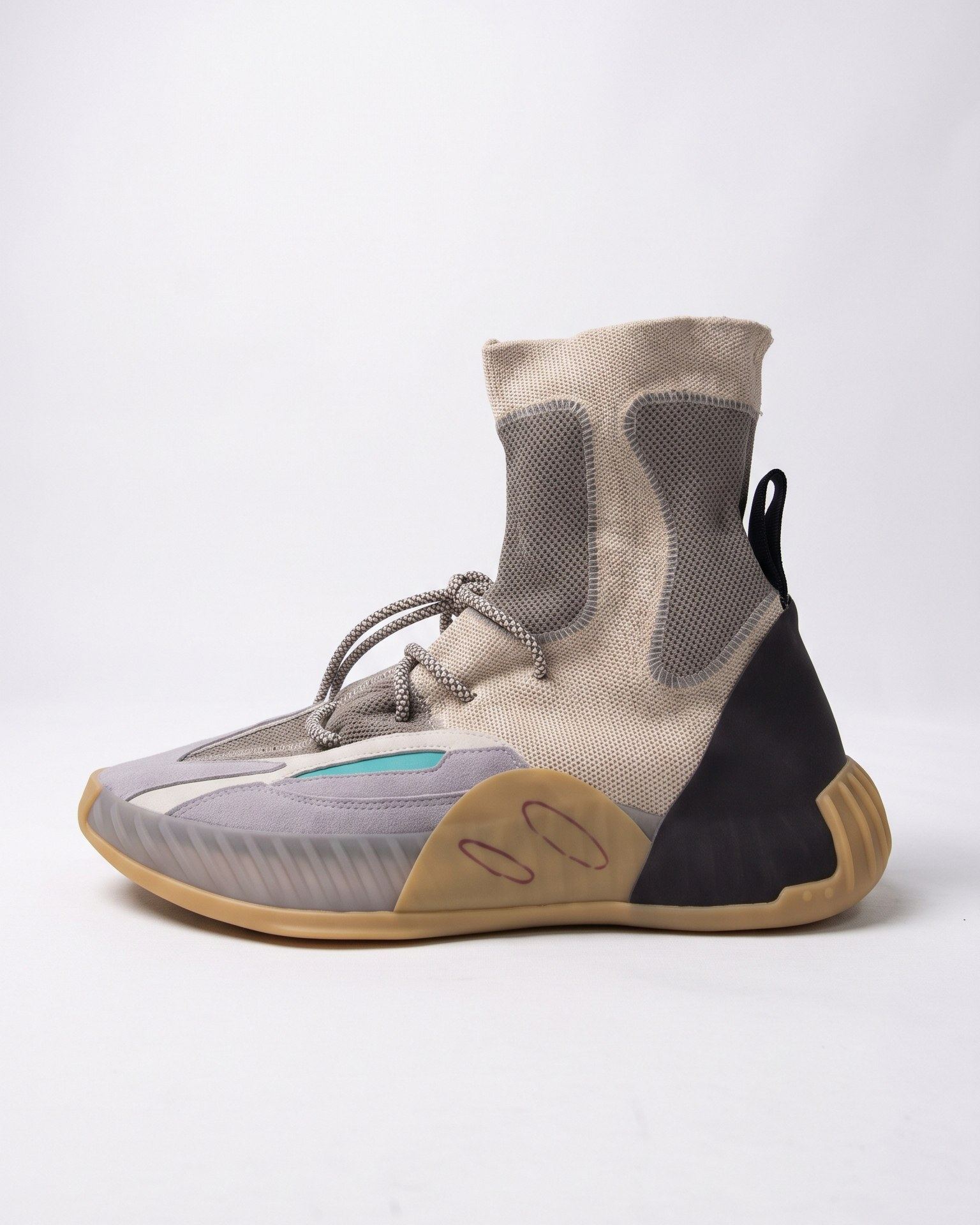 The Version 1 sample, a grey knit high-top with grey laces, a black heel panel, teal accents and a gum cupsole.